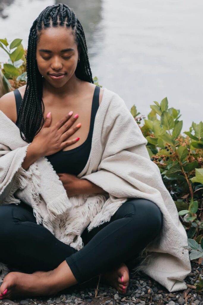 Image of a woman in quite contemplating practicing gratitude a form of Manifestation.