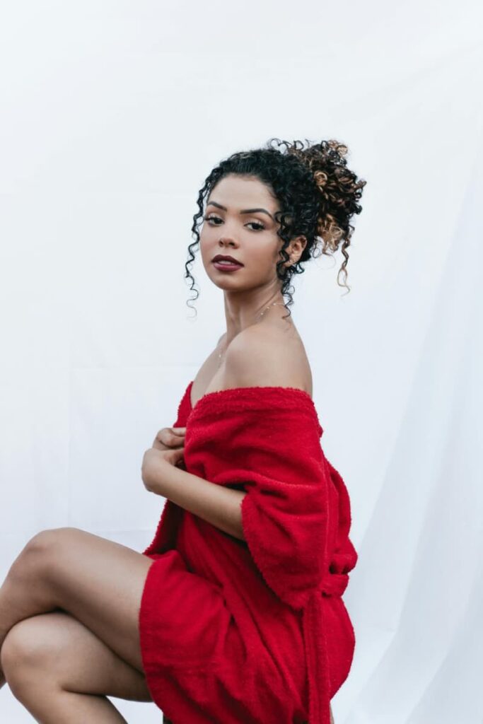 Gorgeous woman in red robe exuding confidence.