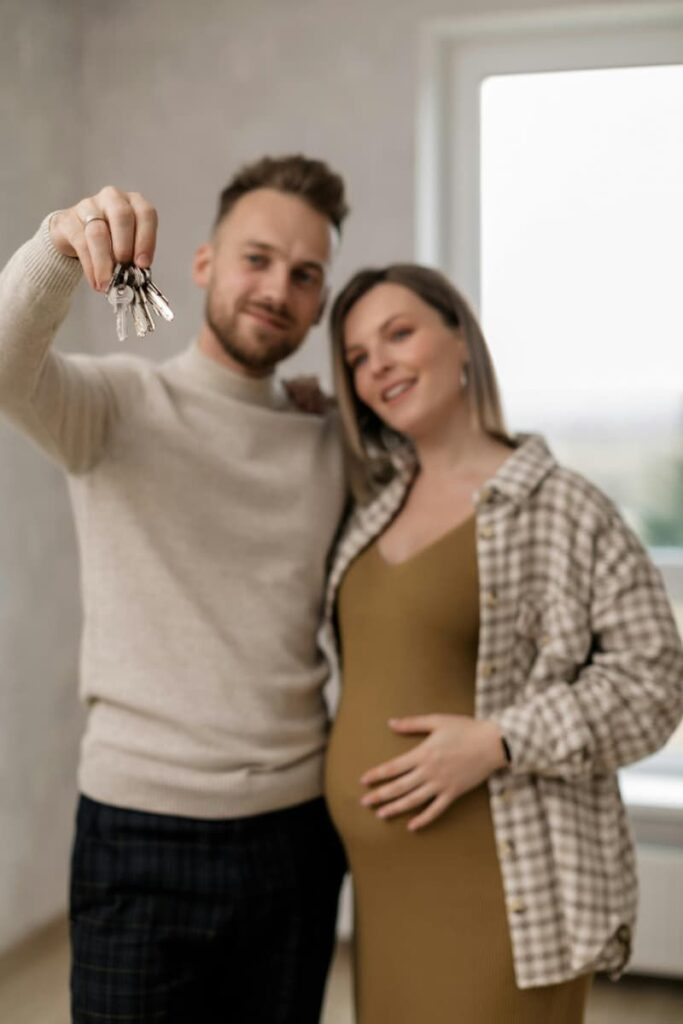 The image of a young expectant couple holding keys to their new house represents what can be achieved through manifestation scripting.