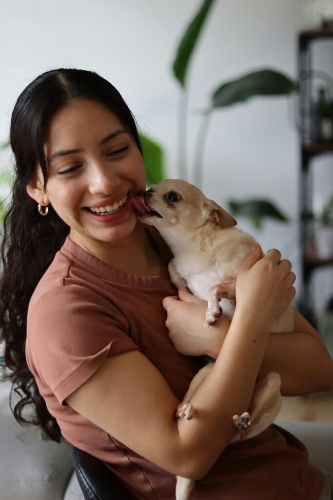 The image of a happy woman with a dog represents overcoming a manifesting block.