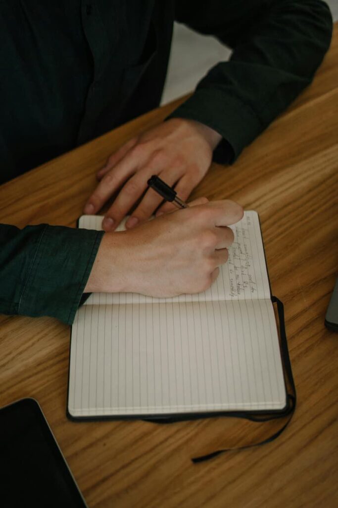 Image of a hand, writing a stream-of-consciousness journal entry.
