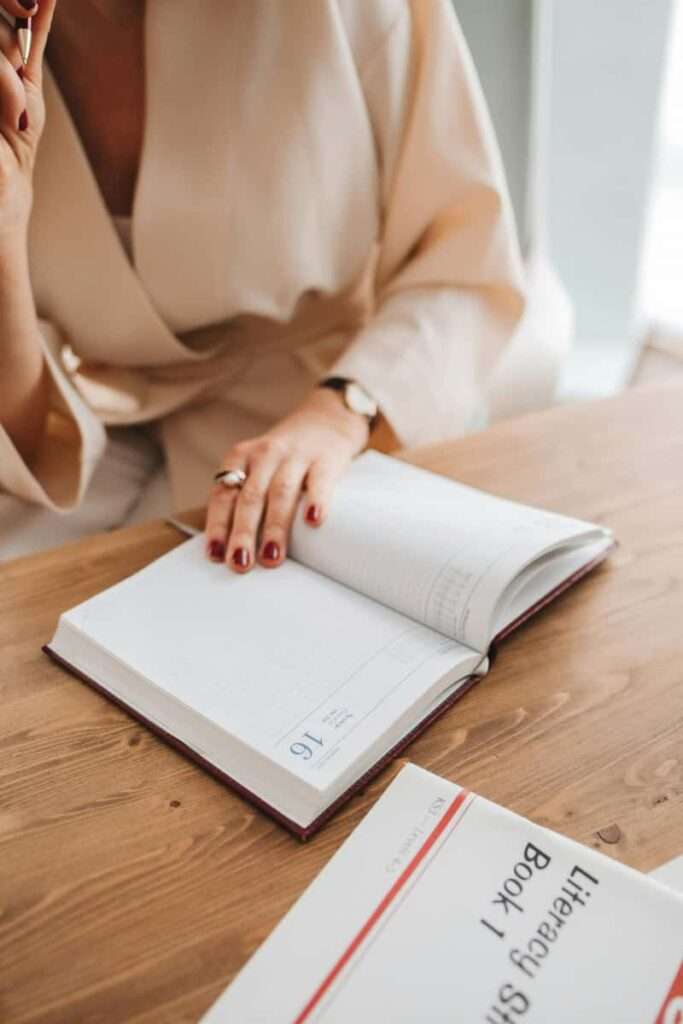 Image of a woman writing in her journal, representing one of the ways to match your manifestation method to your personality.