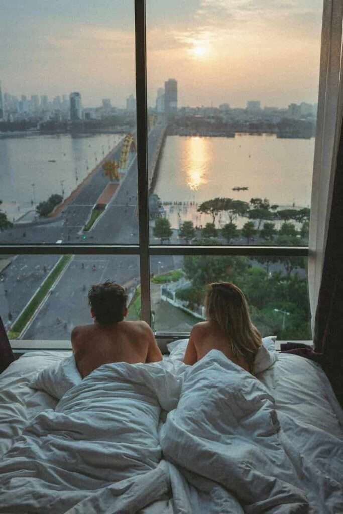 A couple in a luxurious bedroom overlooking a magnificent view representing how cultivating the right mindset can help you manifest abundance.
